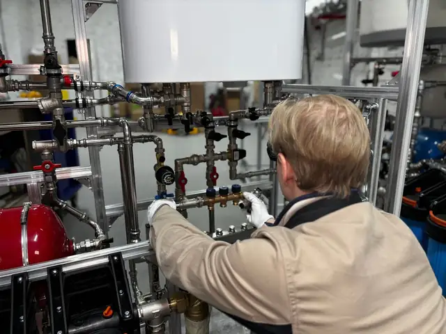 Technician installing piping on a new furnace and boiler system